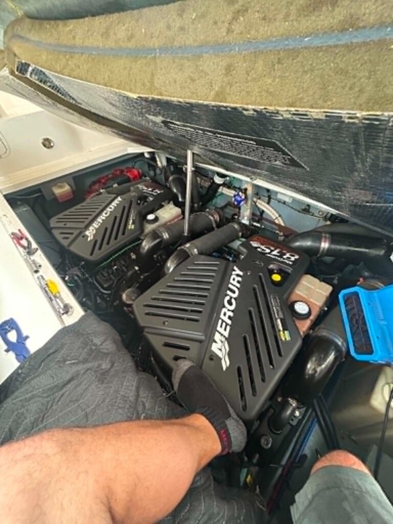 MerCruiser 8.1 sterndrive engine in the bilge during a spark plug and belt tune-up