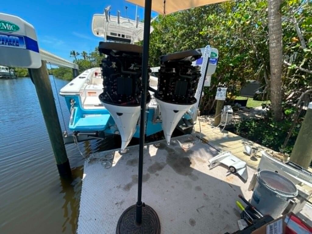 Twin Yamaha 300 outboards with cowls off on a boat lift in Southwest Florida